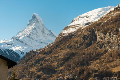 Scenic view of snowcapped mountains against clear sky