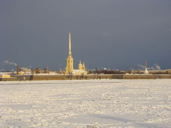 Illuminated building against sky during winter