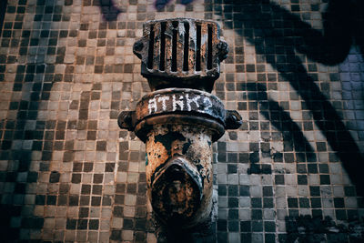 Close-up of metal on tiled floor