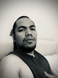 Portrait of young man relaxing on bed at home