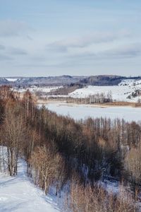 Scenic view of field against sky during winter