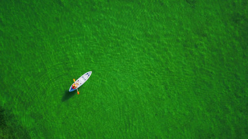 Aerial view of man kayaking in sea