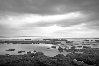 Rocks in sea against sky