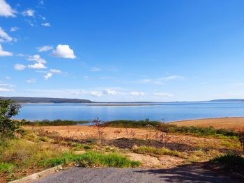 Scenic view of beach against blue sky