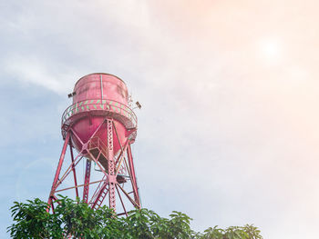 A large red-painted metal reserve water tank was raised to form a tower with a small corridor.