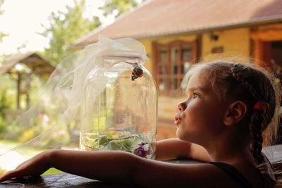 Close-up of girl blowing flowers