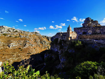 Low angle view of buildings against blue sky
