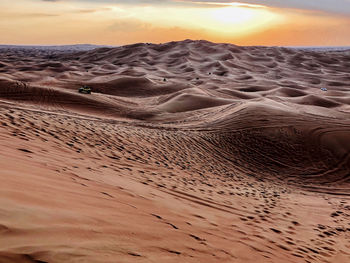 Scenic view of desert against sky during sunset