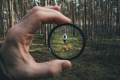 Dog and woman seen through lens