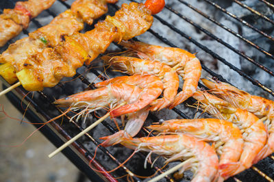 High angle view of meat on barbecue grill