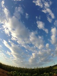 Scenic view of field against cloudy sky