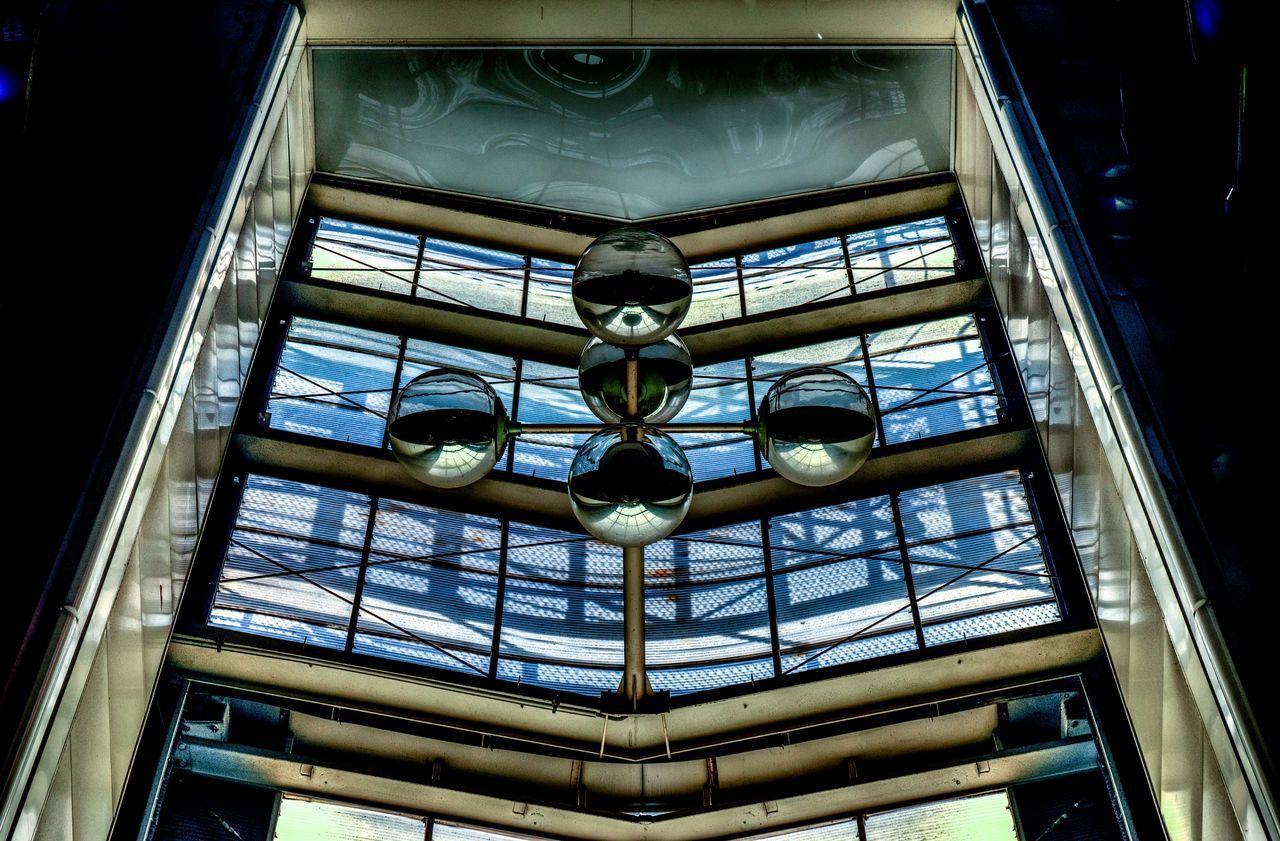 LOW ANGLE VIEW OF SKYLIGHT IN GLASS BUILDING