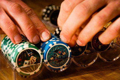 High angle view of person holding casino chips