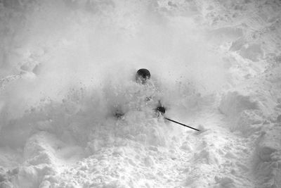 High angle view of person skiing on snow covered hill