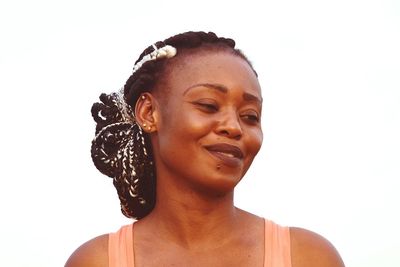 Smiling woman looking down against white background
