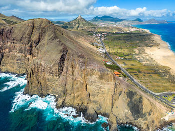 Scenic view of sea and mountains against sky