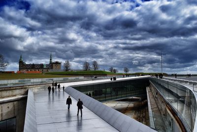 View of bridge over river against cloudy sky