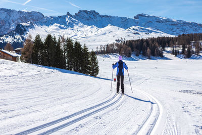 Full length of person skiing on snow covered mountain