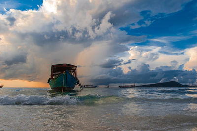 Koh rong island, cambodia at sunrise. strong vibrant colors, boats and ocean