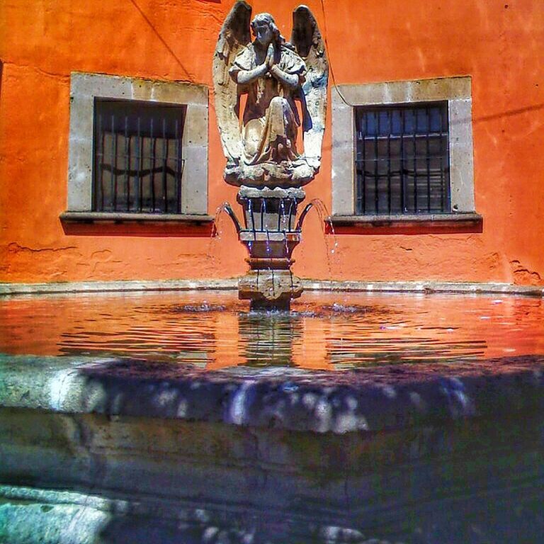 window, architecture, built structure, building exterior, water, human representation, creativity, day, outdoors, facade, waterfront, red, no people