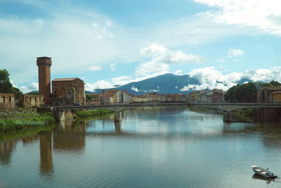 Bridge over river against buildings