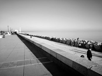 People on beach against clear sky