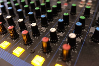 Close-up of knobs on audio equipment