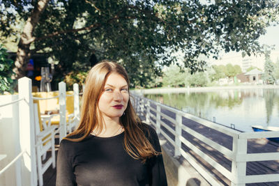 Portrait of woman standing against plants