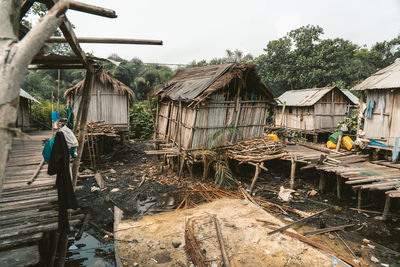 Man working on house by building