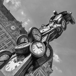 Low angle view of clock against sky