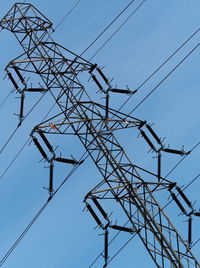 Low angle view of electricity pylon against sky