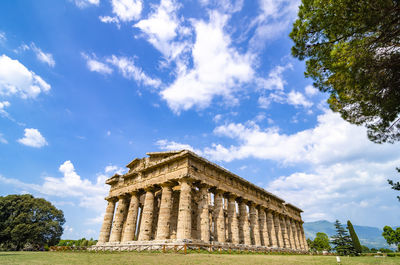 Low angle view of historical building against clear blue sky  , temple of paestum. italy