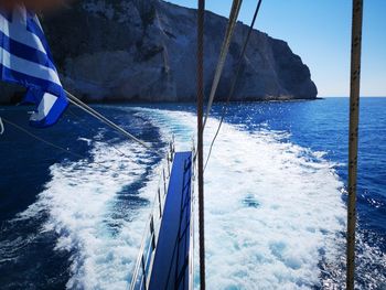 Sailboat sailing in sea against sky