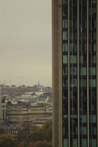 Buildings in city against clear sky