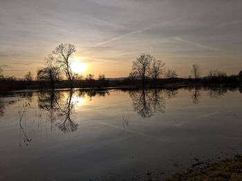 Scenic view of lake against sky during sunset