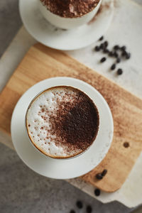 Close-up of coffee cup on cutting board