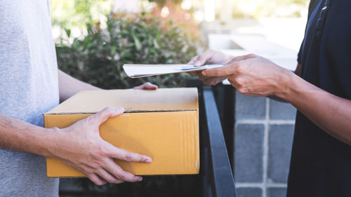 Close-up of hand holding paper with text