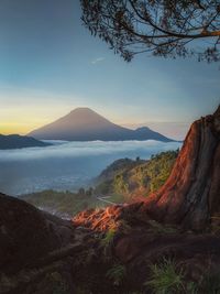 Scenic view of land against sky during sunset