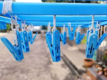 Blue plastic cloth clips hanging on the clothesline