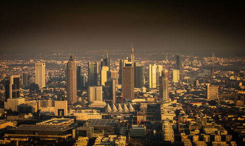 Aerial view of buildings in city against sky