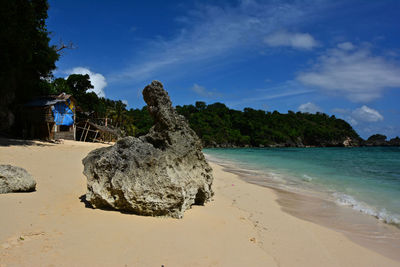 Scenic view of beach against blue sky