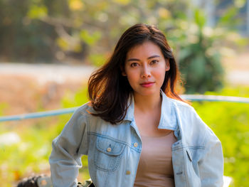 Portrait of beautiful young woman standing outdoors