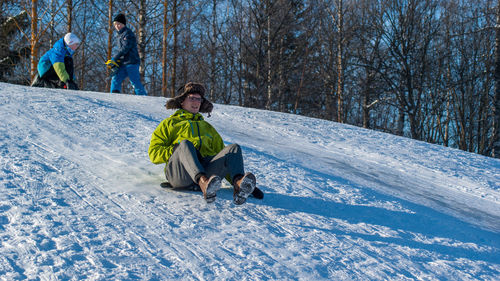 Full length of children playing in snow