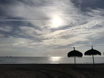 Scenic view of beach against sky during sunset