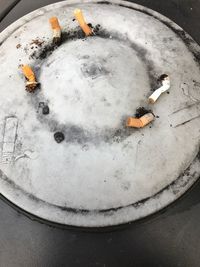 High angle view of cigarette smoking on snow