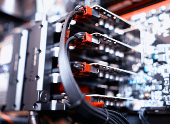 Low angle view of cables with machinery in factory