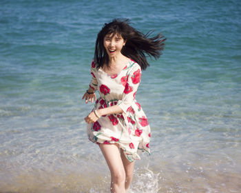 Portrait of young woman in water