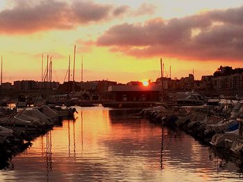 Boats in river at sunset