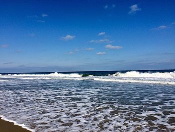 Scenic view of sea against blue sky