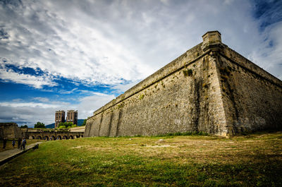 View of old building against cloudy sky